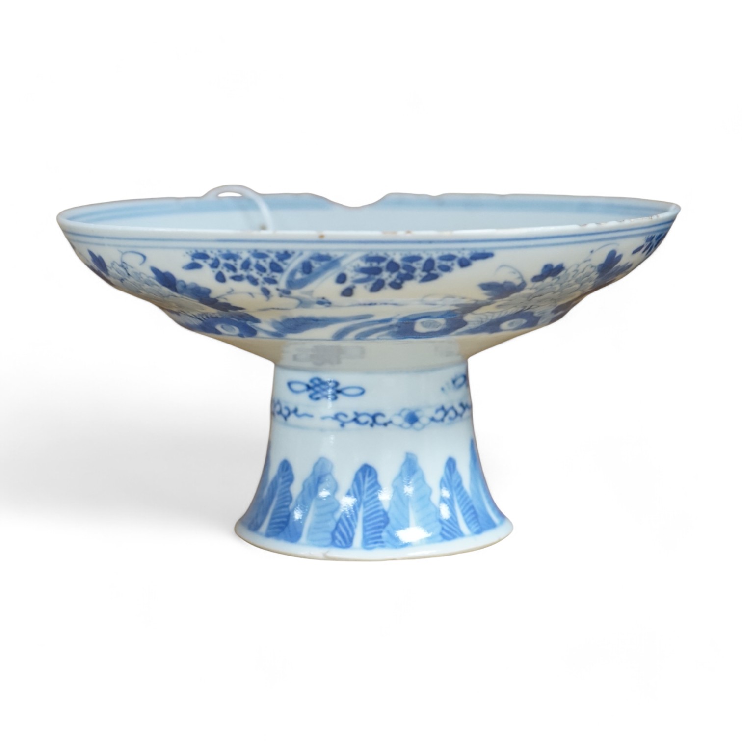 A Chinese blue and white stem dish, Kangxi mark, c.1900. Condition - poor to fair, some significant chipping to rim